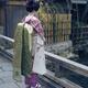 Maiko Geisha apprentice in kimono with long obi belt and okobo shoes a... (thumbnail)