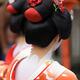 Two Maiko Geishas red kimonos closeup of low collar on back white make... (thumbnail)