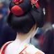 Maiko Geisha in bright red kimono back of her neck makeup and traditio... (thumbnail)