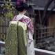 Maiko Japanese young woman apprentice Geiko in a purple kimono with lo... (thumbnail)