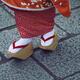 Closeup of Maiko wearing Okobo wooden clogs Japanese Geta footwear on... (thumbnail)