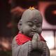 Baby Buddha blessed with a yellow maple leaf fallen on his head cute s... (thumbnail)