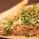 Closeup of Okonomiyaki Japanese dish on a plate cabbage pancake with s... (thumbnail)
