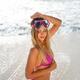 Sexy blond woman in pink bikini swimsuit and swimming goggles on a san... (thumbnail)