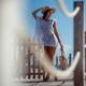 Woman in beach dress and hat with tote bag walking along a sea front b... (thumbnail)