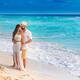 Couple together in an embrace on a sunny sandy sea shore of a Caribbea... (thumbnail)