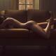 Beautiful sexy outline of a nude woman curvy body on a couch naked in... (thumbnail)