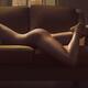Beautiful sexy nude woman lying on a couch body curvy outline Body par... (thumbnail)
