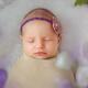 Newborn baby girl sleeping bundled-up closeup of face... (thumbnail)