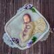 Newborn baby girl sleeping bundled-up in a basket with flowers... (thumbnail)