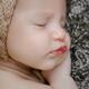Newborn baby girl sleeping closeup of a cute face... (thumbnail)