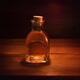 Antique glass bottle with a cork and amber liquid inside artistic stil... (thumbnail)
