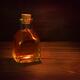 Antique glass bottle with a cork and amber liquid of extract or elixir... (thumbnail)