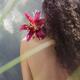 Woman with a lily flower on her shoulder her back with bare skin and l... (thumbnail)
