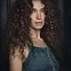 Fine art portrait of a Beautiful girl with big curly dark hair and exp... (thumbnail)