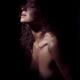 Sensual portrait of a woman closeup of face and neck and bare chest in... (thumbnail)