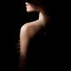 Profile portrait of a woman in black hat with dramatic shadows coverin... (thumbnail)
