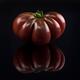Beautiful dark red organic heirloom tomato Black Krim on black backgro... (thumbnail)