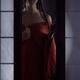 Beautiful Asian woman in undone red kimono standing by an open shoji w... (thumbnail)