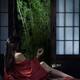 Sexy Asian woman in red kimono drinking tea half undressed by open sho... (thumbnail)