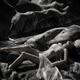 Beautiful nude woman lying by a river her naked body blending with roc... (thumbnail)