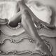 Sexy bare woman legs hanging over footboard of antique bed Sensual Bla... (thumbnail)