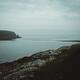 Eastern coast of Northern Ireland with cliffs in dark moody rainy natu... (thumbnail)