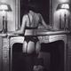 Woman in sexy lingerie by fireplace with a shadowy dark male silhouett... (thumbnail)