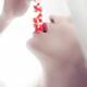 Closeup of a woman taking bright red currants in her sensual mouth wit... (thumbnail)