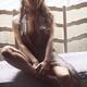 Sexy young woman in unbuttoned dress sitting by an open window in brig... (thumbnail)