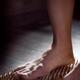 Closeup of a woman with bare feet standing on Sadhu Board Yogic board... (thumbnail)