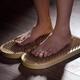Woman standing on Sadhu Board Yogic board of nails with bare feet... (thumbnail)