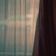 Window behind a sheer curtain in a dark home mysterious indoor scenery... (thumbnail)