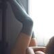 Sexy young woman lying naked in armchair by a window with her legs in... (thumbnail)