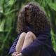 Girl with long curly hair and cute dreamy expression sitting in tranqu... (thumbnail)