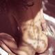 Nude woman on bed with soft sunlight through a window curtain on her b... (thumbnail)