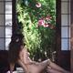 Sexy woman with nude back sitting in sensual pose on wooden floor of o... (thumbnail)