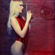 Sexy blond woman in red fashion swimsuit with a gun in her hands Femme... (thumbnail)