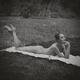 Woman lying naked on a blanket daydreaming on grass in the nature. Bla... (thumbnail)