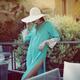 Summer fashion lifestyle portrait of an elegant woman in a turquoise s... (thumbnail)