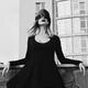 Woman in black dress standing blindfolded on a balcony in outdoor city... (thumbnail)