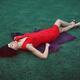 Surreal fashion portrait of extravagant woman in bright red dress lyin... (thumbnail)