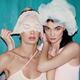 Sensual portrait of two young sexy women playing with a white lace... (thumbnail)