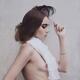 Young woman in a veil headpiece with a feathers and a white scarf bare... (thumbnail)