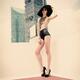 Sexy young woman in black underwear and high heels standing on a rooft... (thumbnail)