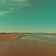 Empty sea beach at low tide in sunrise with wave patterns in the sand... (thumbnail)