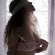 Sexy young woman in pink lace bra with blindfolded eyes caressing hers... (thumbnail)