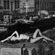 Woman lying topless on a bridge in outdoor city scenery Black and whit... (thumbnail)