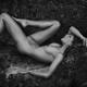 Nude woman lying on rocks in a sexy dynamic pose Black and white fine... (thumbnail)