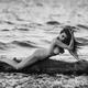 Woman posing nude on driftwood in stormy sea water Fine art nude photo... (thumbnail)